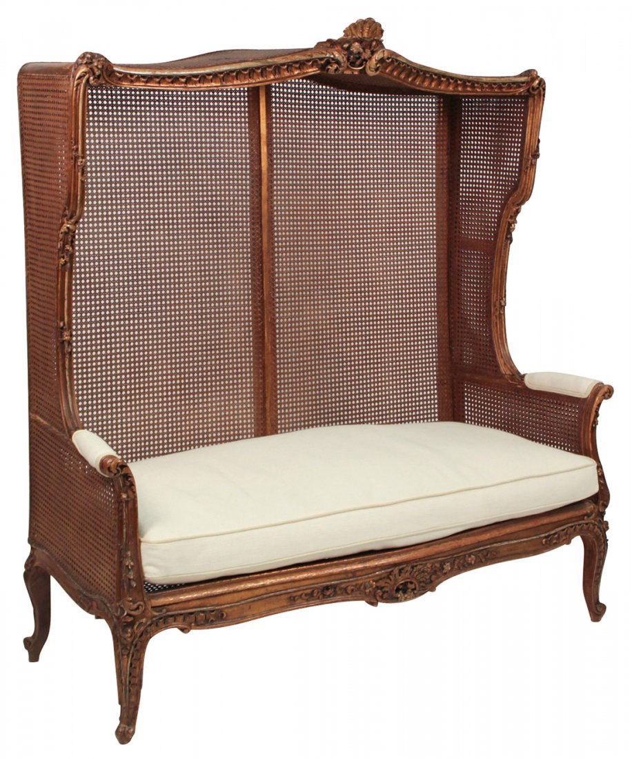 A 19th Century French Louis XV Caned Settee: With Floral Carved Front Rail And Scalloped and Carved Canopy With A Floral Carved Cartouche And Carved Scroll Arms, Circa 1870, 62h X 59 W X 25d