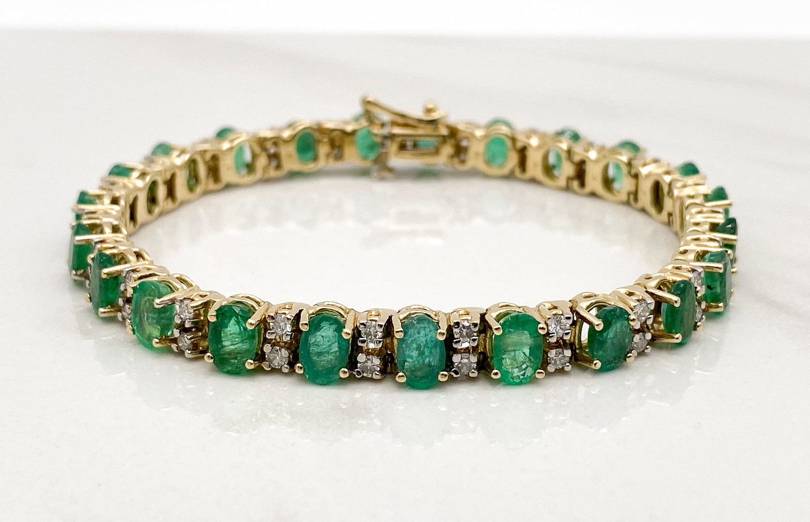 Emerald And Diamond Bracelet, 14k Yellow Gold: Approximately 6.5-7ctw Oval Emeralds And 2ctw J-L, SI2-I1 Round Brilliant Cut Diamonds Set In 14k Yellow Gold Comprising A Bracelet Of 6 3/4 Inches. 19.5 Grams Total Weight One Prong With Slight Bend/
