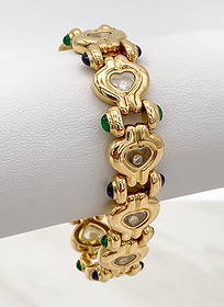 Chopard Happy Hearts Diamond & 18k Gold Bracelet: Chopard Happy Hearts Diamond &18k Gold Bracelet Having Bezel Set Brilliant Round Diamonds Suspended In Hearts, Accented By Cabochon Cut Sapphires And Emeralds. 7 1/8 Inches In Length, 14mm Wide, Weigh