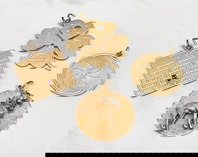 Tiffany & Other Large 14k Gold Pendants, 4 Pieces: Four Large 14k Yellow Gold Pendants With A Total Weight Of 38.3 Grams. One Tiffany & Co. Disc With Swirl Motif, A Clover Set With Aquamarine And Bearing Pisces Symbols, A March Calendar With Ruby Acce