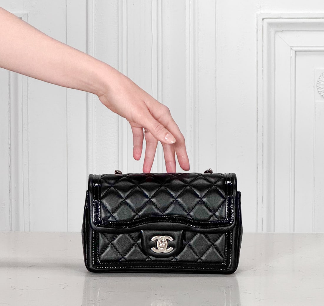 Chanel Black Flap Bag With Patent Trim - 2023: 2023, Black Lambskin And Patent Trim, Light Gold / Champagne Hardware, Microchipped, Retains Plastic Film At CC Turnlock, Zipper Fob And Interior Plaque, Retail Tag Attached And Strap Wrapped In Origi