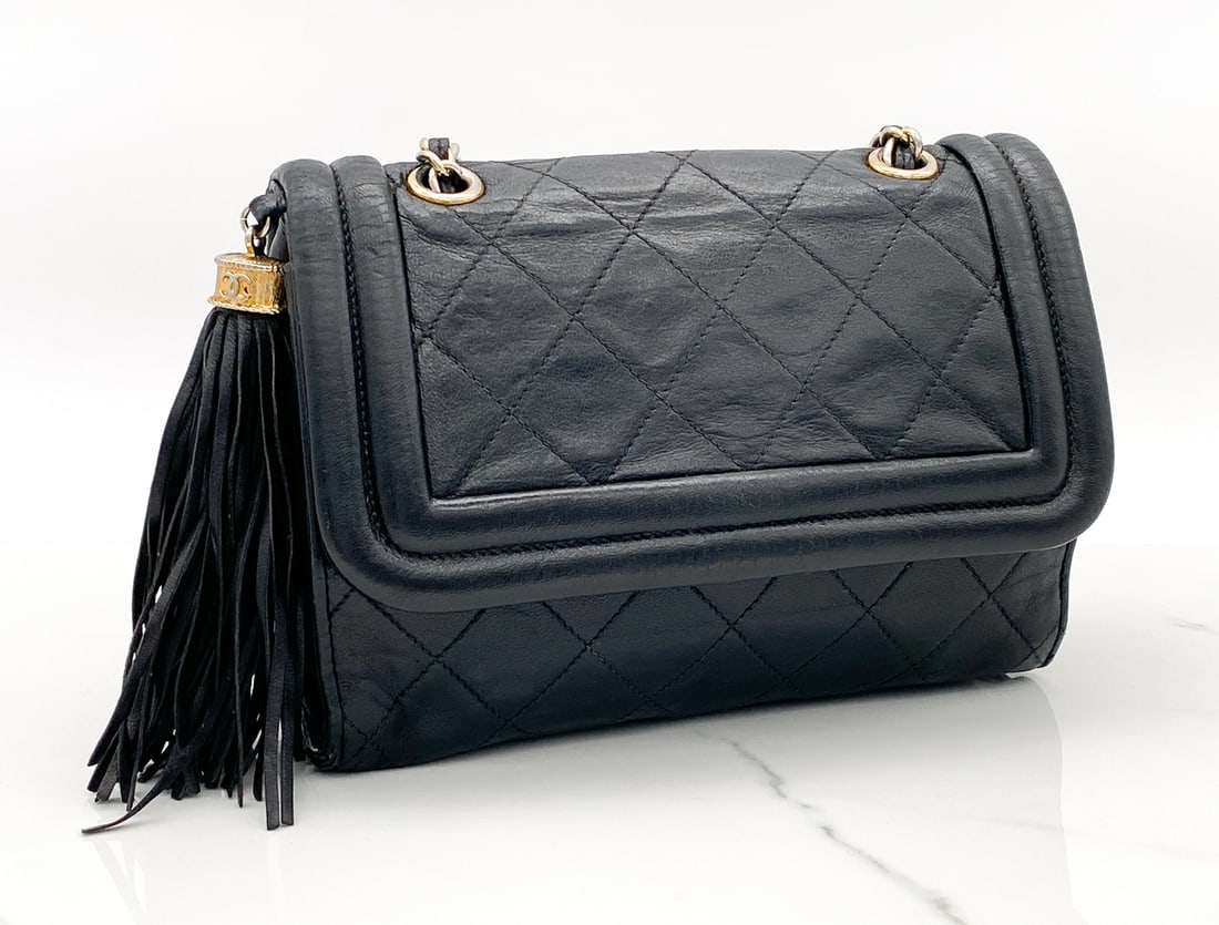 Chanel Tassel Flap Bag: Chanel Tassel Flap Bag, Retains Sticker Indicating Production Date 1989-1991, Gold Plated Hardware, 5.5 X 7.5 X 2 Inches, Strap Drop 18 Inches Some Oxidation To Hardware, Slight Impression Marks To