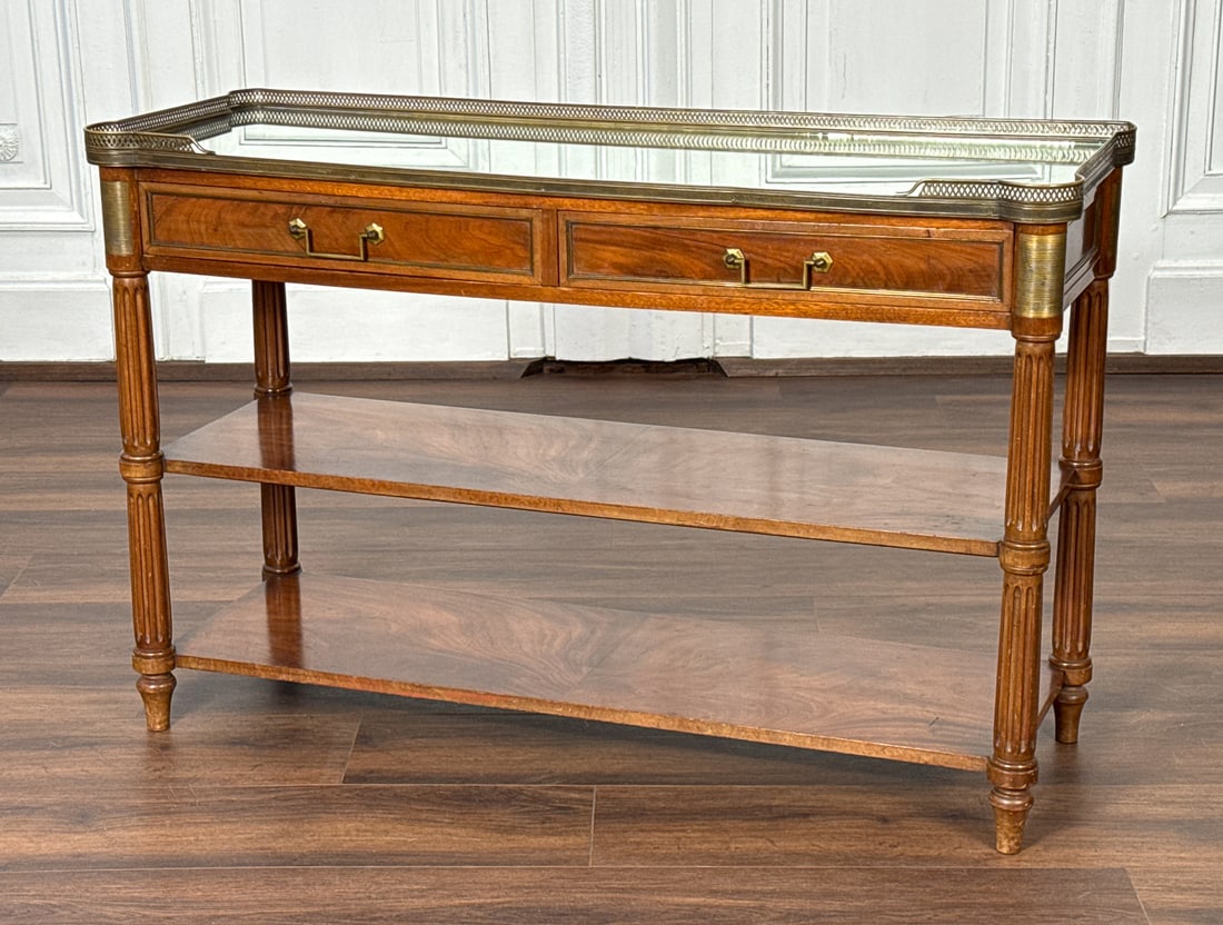French Louis XVI Style Console Table: French Louis XVI Style Console Table, Inset With Mirrored Top, Two Drawers Over Two Open Shelves, Bronze Hardware, Height 37 Inches Including Gallery, Width 48, Depth 17 Inches, Small Chip To Mirror