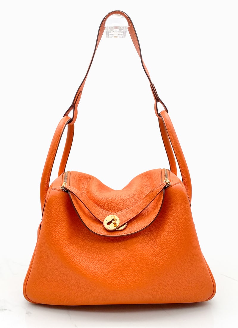 Hermes Lindy 30 Orange Clemence Bag: Hermes Lindy 30 Orange Clemence Bag, L Stamp, 2008, Gold Toned Hardware Retains Protective Film At Turnlock Plate And Tabs, Overall Clean Exterior, Wear And Color Transfer To Underside Corners, Scuffi