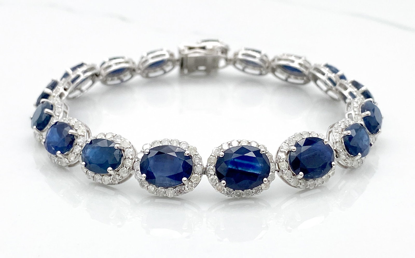 Sapphire & Natural Diamond 14k Bracelet: Sapphire & Natural Diamond 14k Bracelet, 26.87ctw Sapphires Surrounded By 4.20ctw Natural Diamonds Of G-H Color, Si2-I1 Clarity, 14k White Gold Setting, Length 7.25 Inches, Total Weight 17.0 Grams. Wi