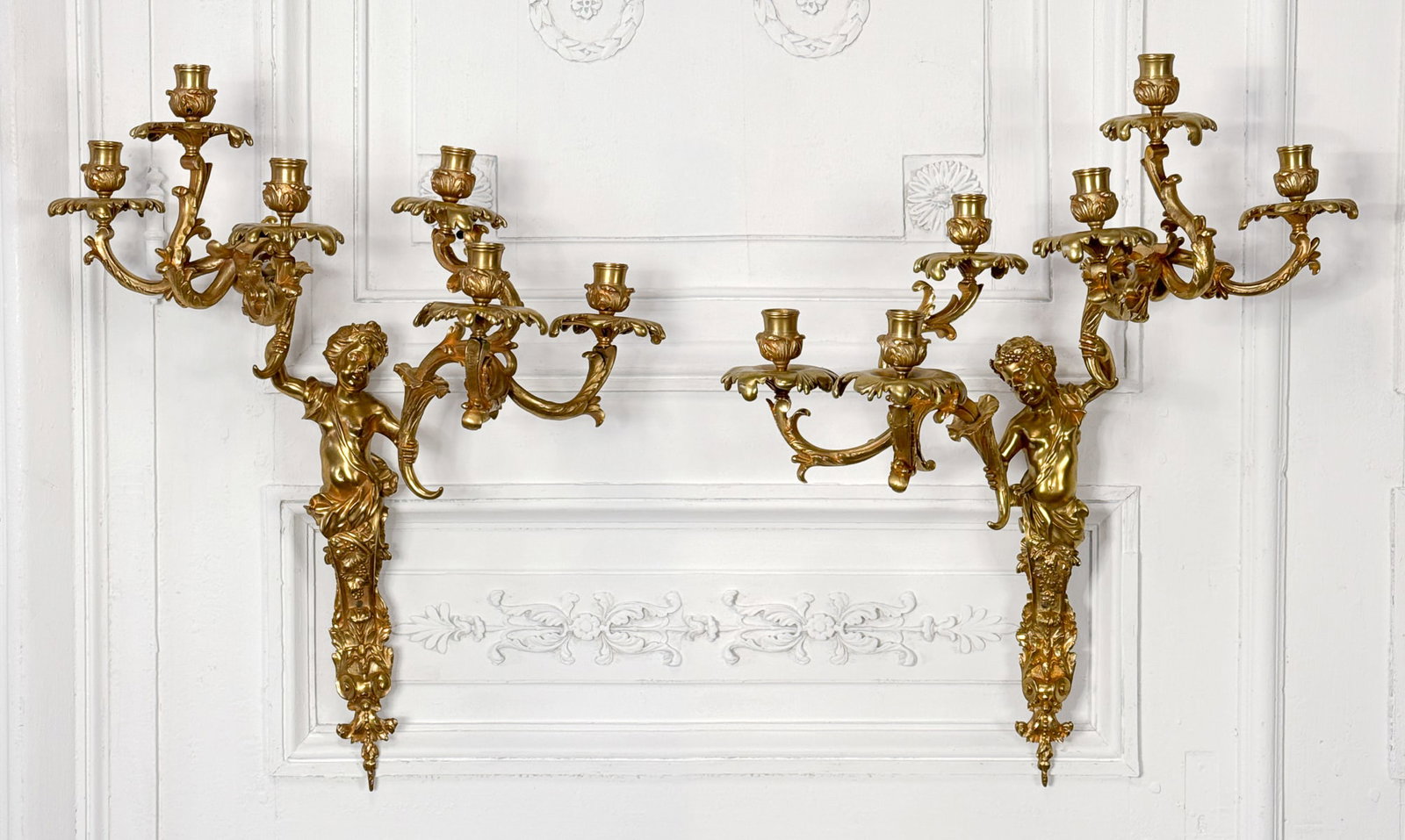 Pair Antique French Rococo Style Bronze Sconces: Pair Antique French Rococo Style Bronze Sconces, Each With Six Lights On Foliate Arms Held By Putto Term, Height 23, Width 19, Depth 8 Inches, Not Electrified, From The Collection Of Thomas Grant, Dal