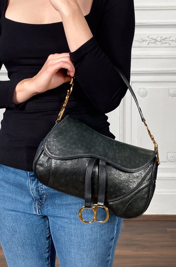 Christian Dior Black Ostrich Saddle Bag: Christian Dior Black Ostrich Saddle Bag, John Galliano Era, Early 2000's, Gold Tone Hardware, Interior Tab Marked Ru 0050, Made In Italy, Approximate Height 7 Inches, Width 11.5 Inches, Depth