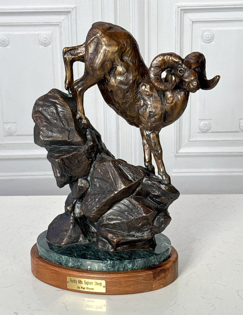 Paul Rhymer, American, Born 1962: Paul Rhymer, American, Born 1962, 21st Century, Rocky Mountain Bighorn Sheep, Bronze Marked 2011 11/58, Verde Marble Base And Wood Plinth, Height 18, Width 13, Depth 9 Inches