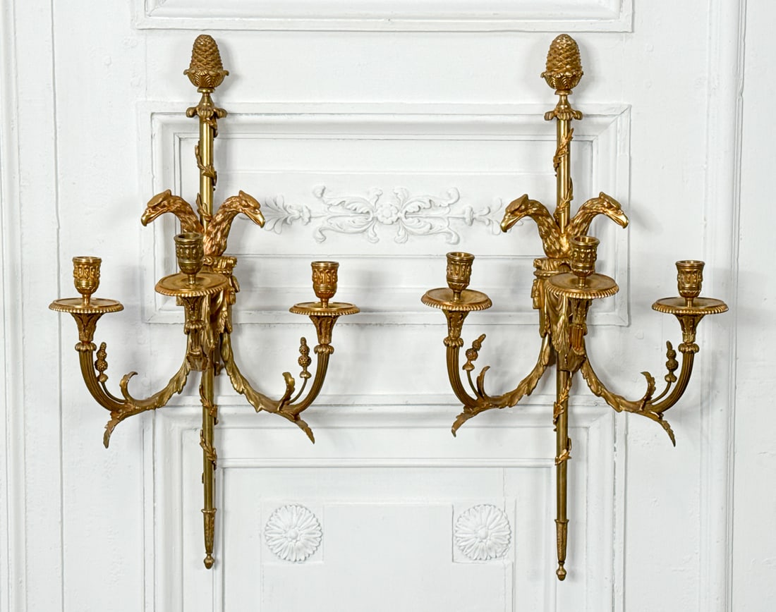 Pair Louis XVI Style Gilt Bronze Sconces: Pair Louis XVI Style Gilt Bronze Sconces, Each With Acorn Finial, Laurel Wrapped Staff, Double Eagle Head Mount With Drape Issuing Three Candle Cups On Upswept Arms, Height 25, Width 13.5, Depth 8 Inc