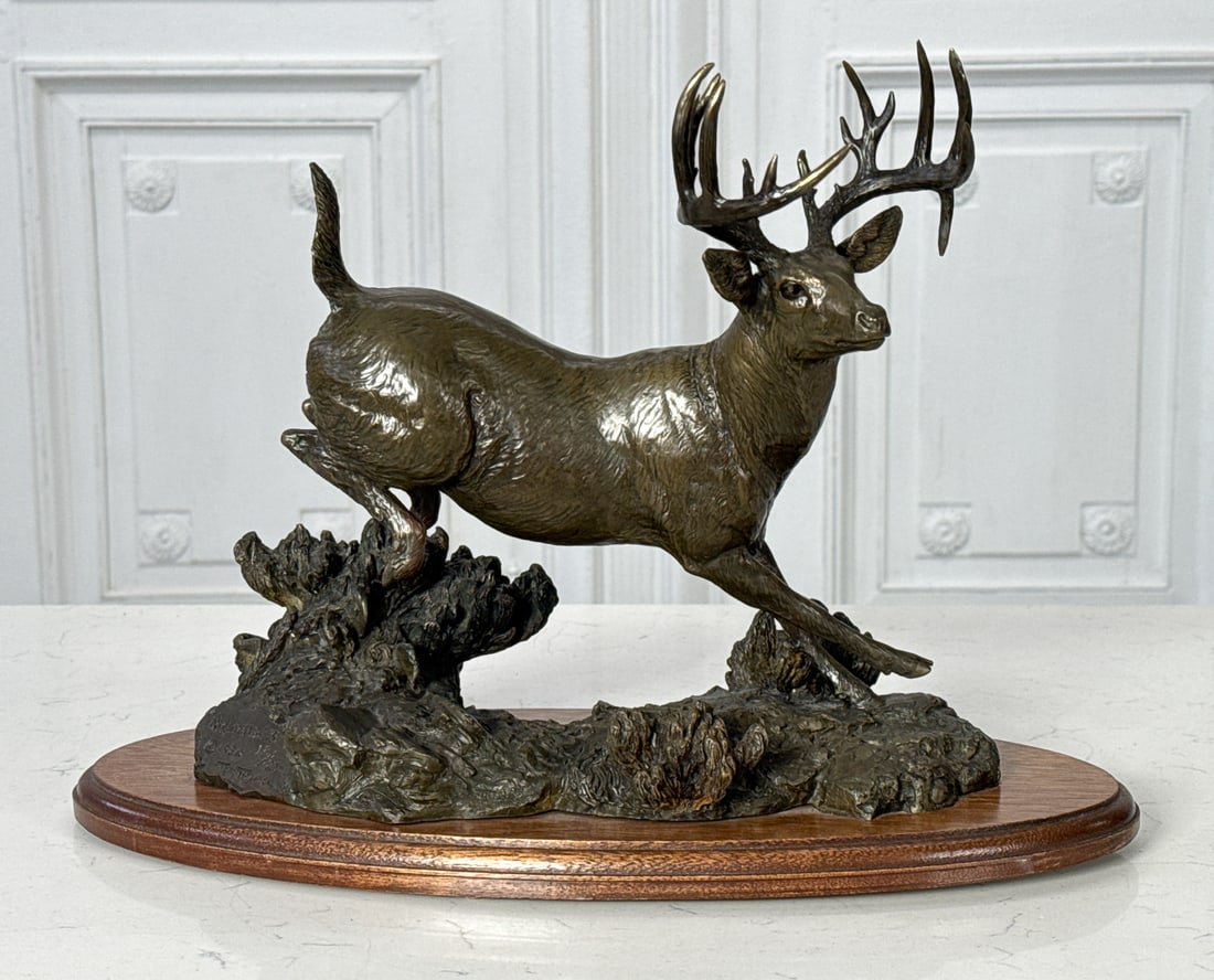 Tom Tischler, American, Texas, Born 1950: Tom Tischler, American, Texas, Born 1950, High Tailin' Whitetail Deer, Buck, 1980, Bronze, Titled, Signed, Dated And Edition 18/25 On Base, 10 X 12 X 6 Inches, On Oval Walnut Plinth, Overall 11 X 16