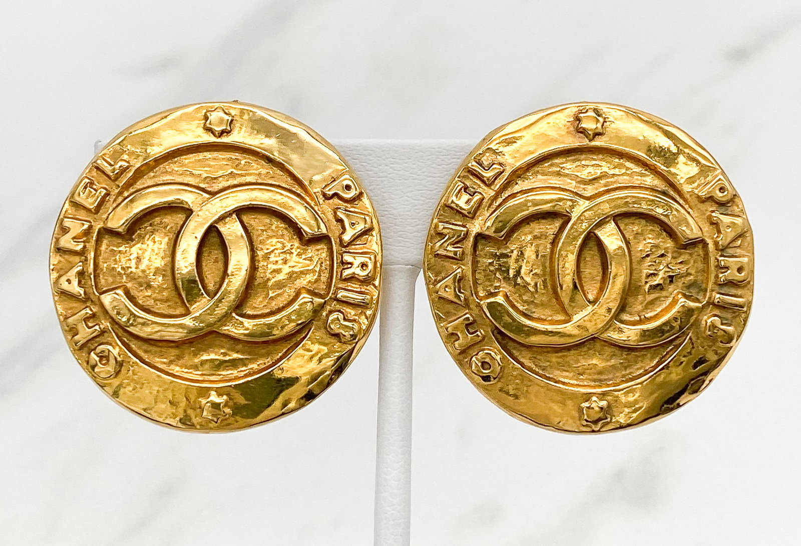 Pair Chanel Button Logo Earrings: Pair Vintage Chanel Button Logo Earrings, Circa 1990, Gold Tone Finish, Each Marked 2853 And Chanel Verso, Clip Backs. Diameter 2.5 Inches, Includes Original Box. View All Photos For Additional