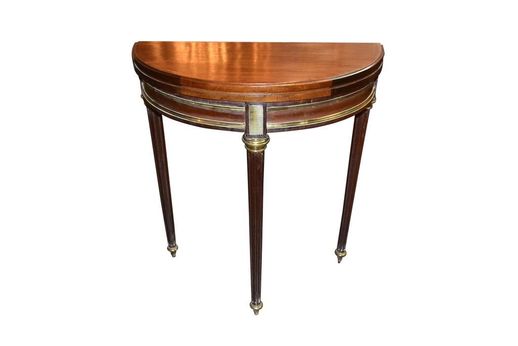 French Directoire Games Table: 19th c. mahogany with brass inlay. demi-lune shape, folding to round. green felt top. 27.5w x 14d x 29h