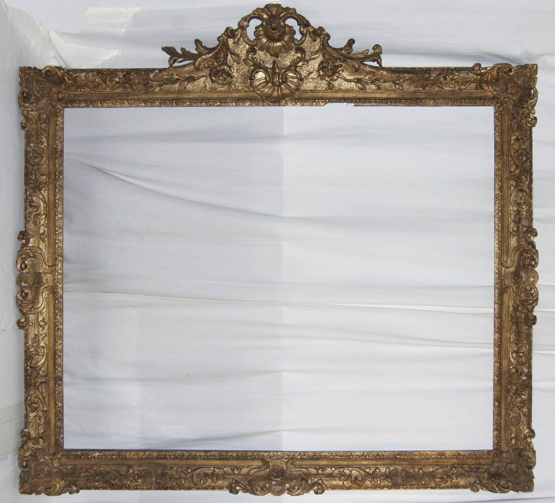 Large English early 18th C. carved and pierced frame: Large English early 18th C. carved and pierced gilded frame with foliate sight, sand frieze and scolling leaf with larger top center cartouche 44 x 55 W: 5.5