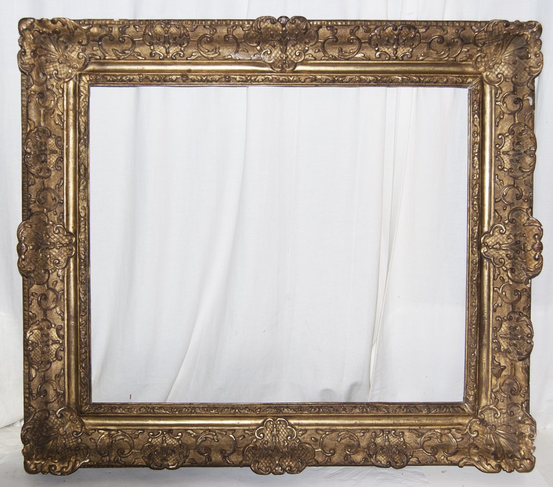 French Louis XIV carved and gilded frame: French Louis XIV carved and gilded frame with corner and centre cartouches and sand frieze. 26 X 31 W: 5.5