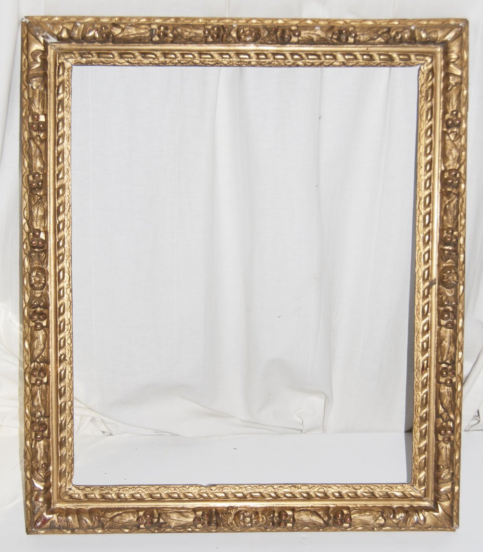 French XIII louis hand carved and gilded frame: French XIII louis hand carved and gilded frame with ribbon twist and flower and berry D section top 21 x 25 W: 3