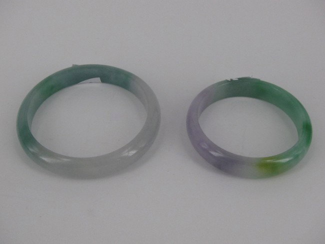 TWO CHINESE JADE BANGLES: Diameter inside 2 1/8 and 2 1/2"