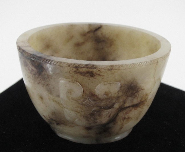 ANTIQUE CARVED JADE CUP: Han Dynasty with animal masks in relief, ring base. Height 1.75", Diameter 2.75"