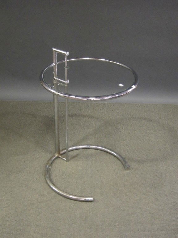 EILEEN GRAY: A 20th C. modern design chrome framed circular telescoping occasional table having an insert glass top. 20" in diameter and 25.5" in height.