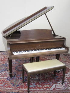 STEINWAY BABY GRAND PIANO: A Steinway + Sons mahogany cased model "M" baby grand piano with matching bench. The whole raised on square tapering legs terminating on spade caster feet serial # E2816. (333803)68x57.5x38LxWxH