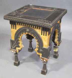 GOOD CARLO BUGATTI SQUARE MOORISH STYLE STOOL: (1856-1940) PEWTER MOUNTED WITH FAUX BAMBOO INLAY. RAISED ON A BLOCK BASE WITH VARNISHED PARCHMENT APRON WITH MOORISH ARCHED SUPPORTS WITH EBONIZED TRIM. IVORY AND COPPER EMBELLISHED. N TAPERED,INCISE