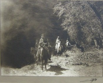CURTIS, EDWARD SHERIFF (1868-1952, American): Sepia photograph. Depicting Native Americans on horseback. Signed lower right in margin in black ink Curtis. Numbered in plate 100-04. Unframed. 9.75" h x 12" W overall Note: Pin holes to all four cor
