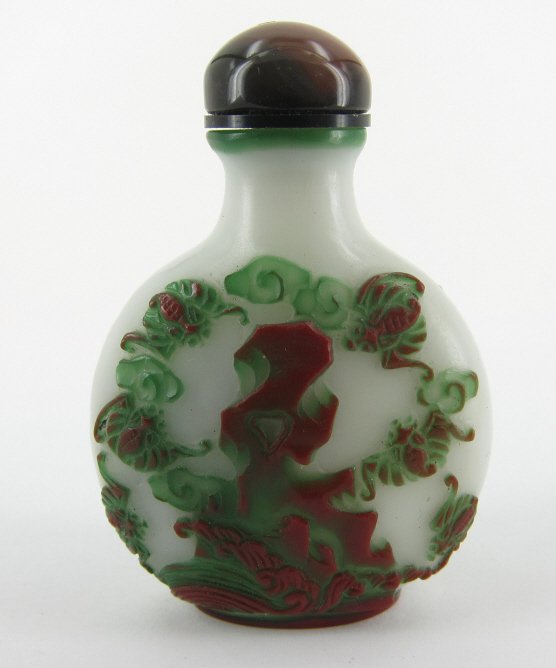 ANTIQUE SNUFF BOTTLE:: A 19th C. Chinese lidded snuff bottle (1850-1900). Two color glass overlay in green and brown. Each side depicting bats in a landscape. Signed. 2.5" in height.