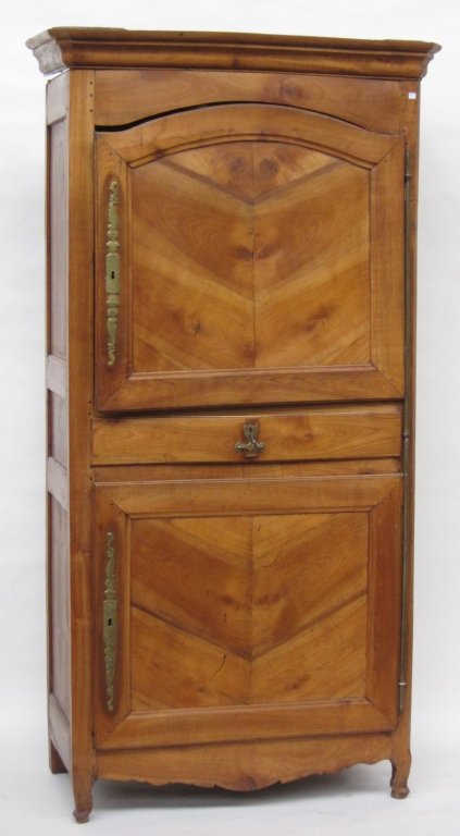 FRENCH CABINET: A 18th century French Louis XV provincial fruitwood tall storage cabinet. The moulded cornice above a single atrium form door, having a recessed panel, above one long drawer over a similar lower cabin