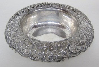 WILLIAM WISE & SON STERLING SILVER CENTERPIECE: With broad overhanging recticulated foliate scrolled rim. The bowl interior with chased foliate decoration. H. 3.75, Diam. 10.5." 23.5 Troy ozs.