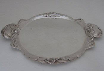 REED & BARTON STERLING SILVER CIRCULAR TRAY: Twin handled with Art Nouveau floral repousse design. 10.5" x 12.75", 17.2 Troy ounces. Provenance: From the Fried Estate, Bedford NY Collectors for over 75 years.