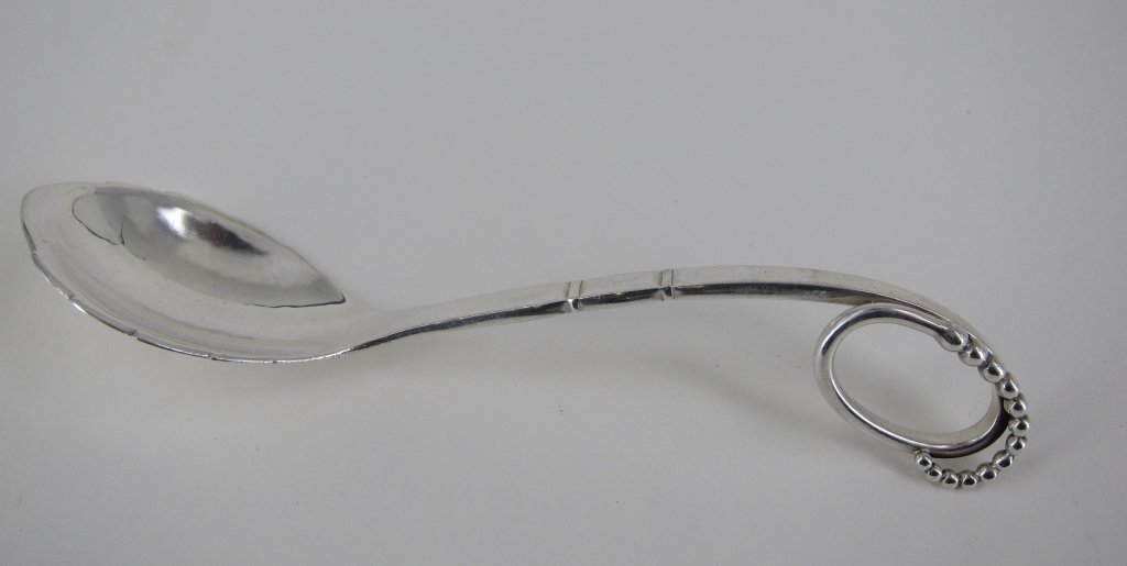 GEORG JENSEN STERLING SILVER SPOON: With beaded loop end and shaped bowl. Marked Denmark. L. 5.25." 1 Troy oz. Provenance: From the Fried Estate, Bedford NY Collectors for over 75 years.