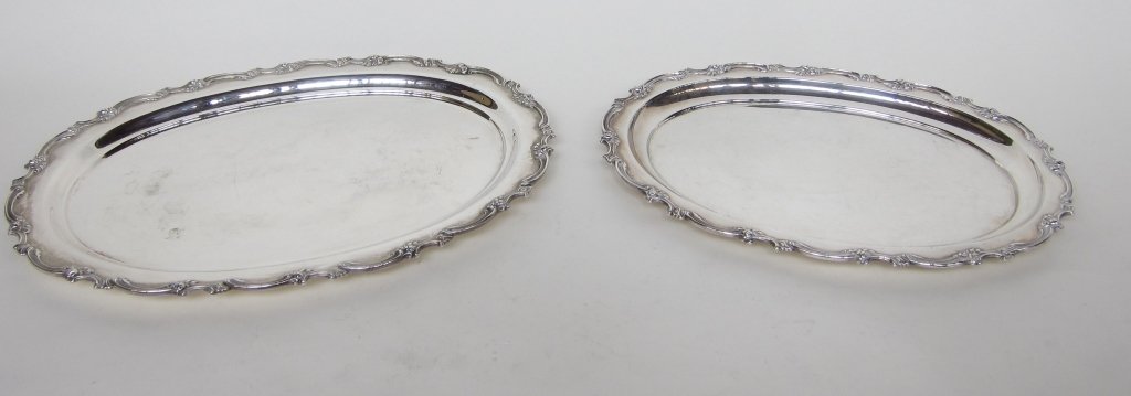 TWO STERLING SILVER GRADUATED TRAYS: By Mauser. Ovals with raised scrolled rims bands. L. 16 and 18.5." Total 74.4 Troy ozs. Provenance: From the Fried Estate, Bedford NY Collectors for over 75 years.