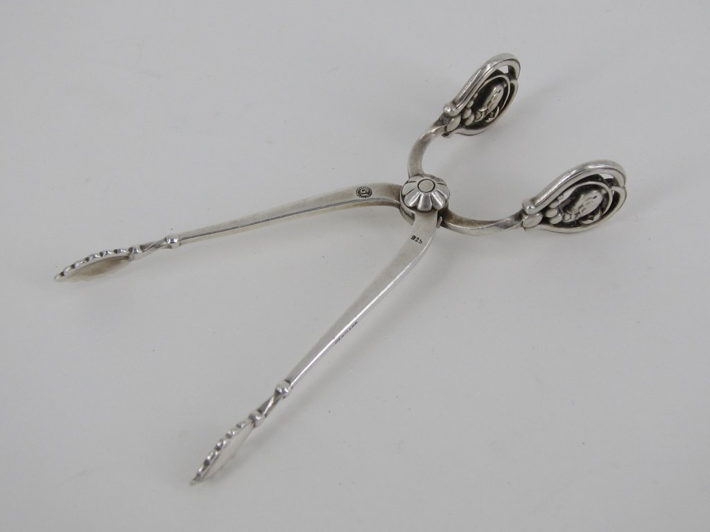 GEORG JENSEN STERLING SILVER SUGAR TONGS: Marked Denmark. The "Blossom" pattern. L. 3.75." .75 Troy ozs. Provenance: From the Fried Estate, Bedford NY Collectors for over 75 years.