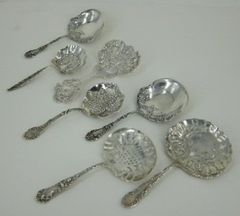 GROUP SMALL ANTIQUE STERLING SILVER SERVING SPOONS: Slotted sugar sifters by Gorham (two), Daniel Low & Co., Whiting, and Alvin. Along with a pair of Theodore B. Starr broad bowl spoons. L. largest 5.25." Total 6.4 Troy ozs. Provenance: From the Fried 