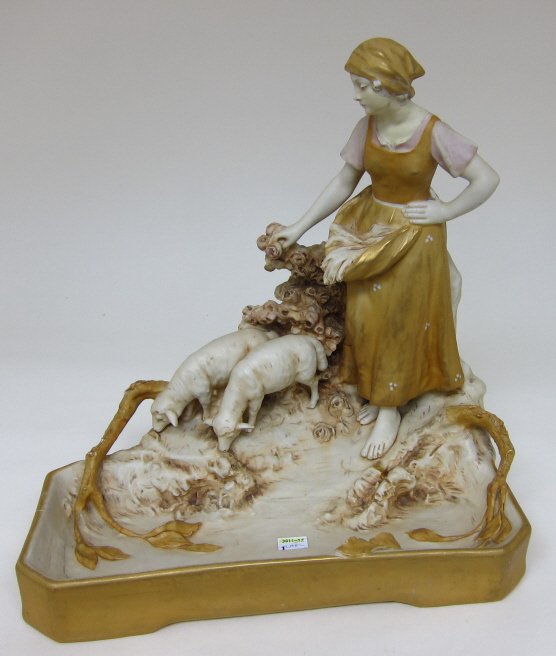 ROYAL DUX FIGURAL GROUP: A shepherdess with her flock of sheep in a bramble with roses. Pink mark on the bottom. Porcelain in ecru with some pink paint and gilt. L. 13.5, Depth 9.25, H. 14.5."