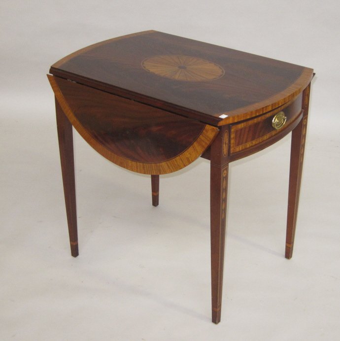 PEMBROKE TABLE: A 20th Century Hepplewhite style satinwood banded flamemahogany pembroke table manufactured by "Councill Craftsmen". The twin bowed end rectangular top above one short conforming recessed frieze drawe