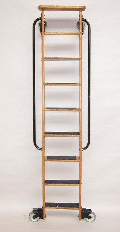 INDUSTRIAL LIBRARY LADDER: A solid oak constructed ladder with iron side handrails having 8 steps and wheel rollers. W. 16, H. 89.5."
