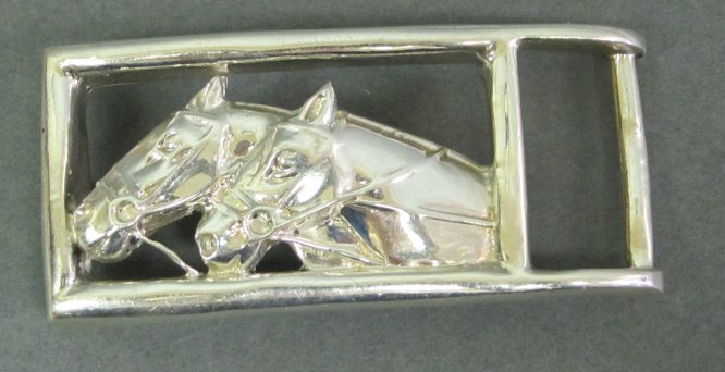 BARRY KIESELSTEIN CORD SILVER HORSE BELT BUCKLE: In the form of two horse heads in a rectangular frame. 1 1/8 x 2 3/8." Stamped marks on the back.