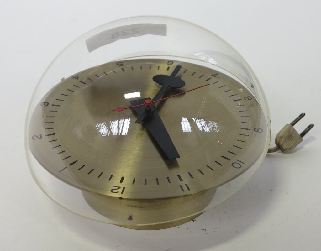 HOWARD MILLER MODERN WALL CLOCK: Polished brass with plastic dome cover. Diam. 6.5."