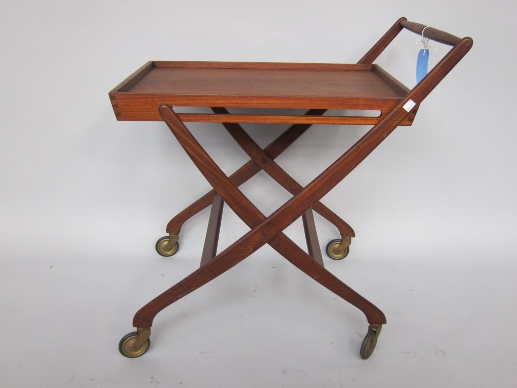 DANISH MODERN SERVING CART: A mid 20th c. Danish modern design Teakwood collapsible serving cart on caster feet. 28' L. x 19.5" W. x 29.5" H.