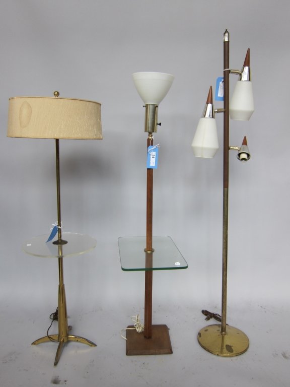 MODERN LIGHTING: A group of three mid 20th c. modern design lamps. Comprised of two lamp tables, one with a teakwood standard, and one floor lamp having cone form shades. The tallest measures 62" H.