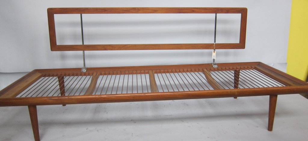 PETER HVIDT: A mid 20th c. Danish modern teakwood daybed by Peter Hvidt. The rectangular back raised on chrome tubular supports, above a conforming seat raised on tapering cylindrical legs. Bears makers label on s