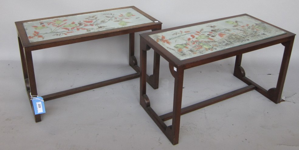 PAIR SIDE TABLES: A pair Mid -20th Century modern walnut rctangular side tables. Each fitted with an eglomise mirrored panel in a flowering banch motif. The walnut rames fitte with a "H" center stretcher support." Meas