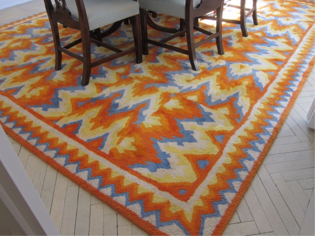 EDWARD FIELDS CARPET: Of abstract design in tones of orange, blue, yellow and ivory. 10' 2" x 12' 2" Provenance: Property from an exceptional Park Avenue, Manhattan, NY Estate.