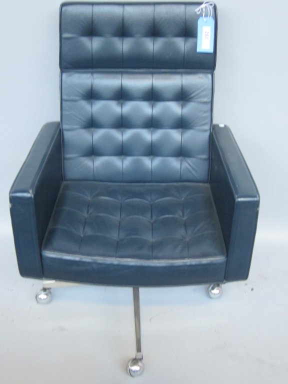 VINCENT CAFIERO: a mid 19th century modern black button tufted leather executive swivel chair designed by Vincent Cafiero for Knoll International. the whole raised on 4 chrome legs resting on caster feet. 39.75" in ht