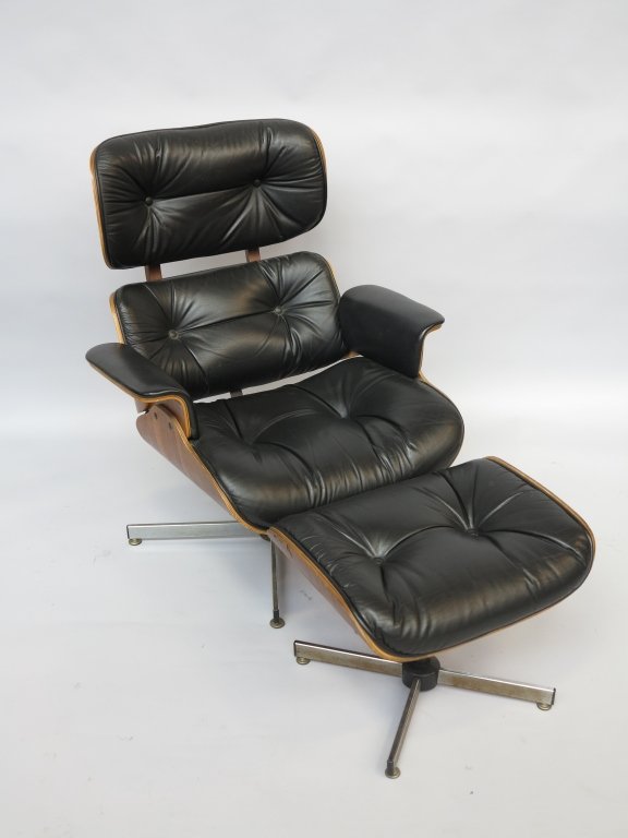 EAMES STYLE LOUNGE CHAIR WITH OTTOMAN: A mid 20th century modern Charles eames style walnut plywood veneered and block bottom tufted leather upholstered swivel arm chair with matching ottoman . 38" in ht