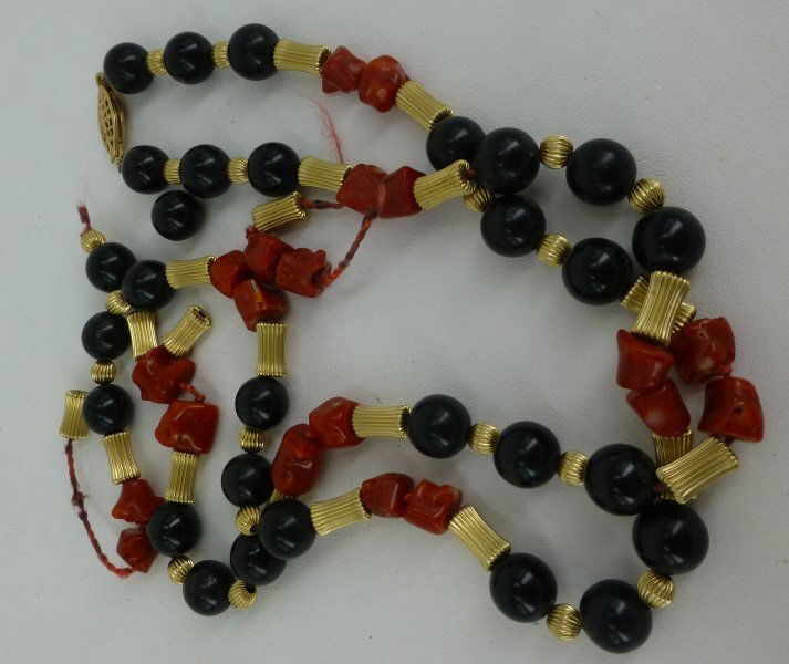 NECKLACE: 14k gold, ebony and coral necklace. Note: In "As Is" condition. Measures: Provenance: Property from East 64th St, Manhattan, N.Y. home. Pre-Sale Estimate: $75/125