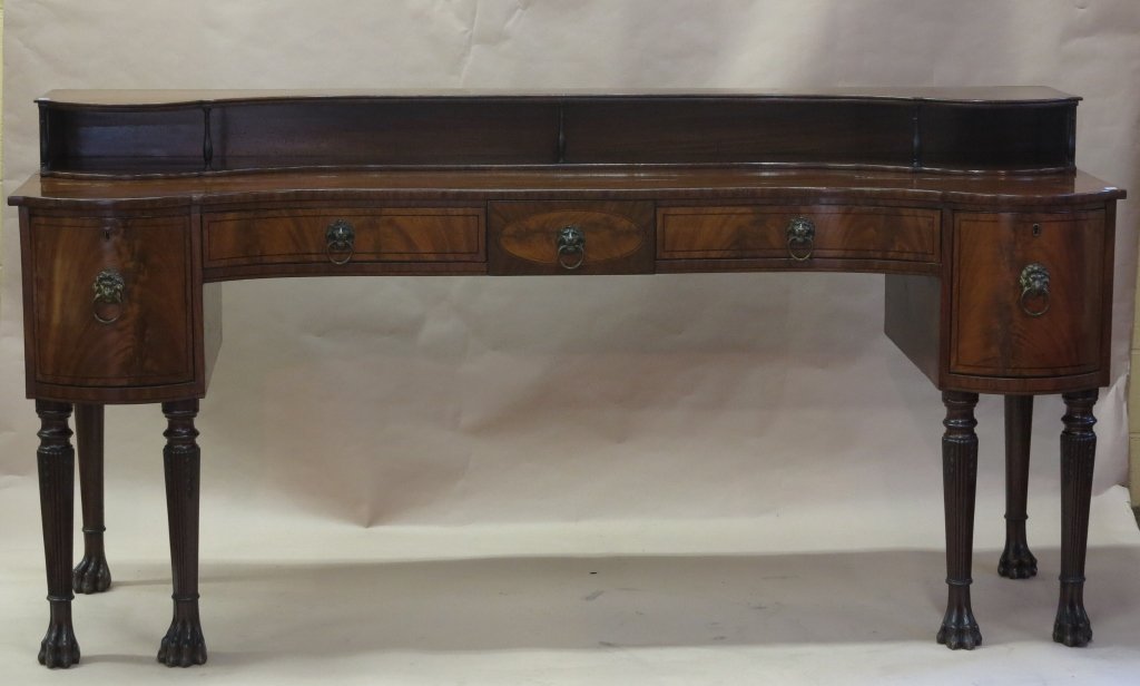 SHERATON SIDEBOARD: A 19th c. English Sheraton mahogany double pedestal sideboard, the shaped rectangular top fitted with a conforming shelf gallery, above one center short drawer flanked by two long conforming drawers. 