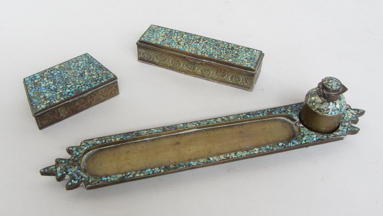 ANTIQUE PERSIAN DESK SET: Brass four piece with pen tray, ink bottle and two small boxes. All with tops inlaid with pieced turquoise. L. tray 9."