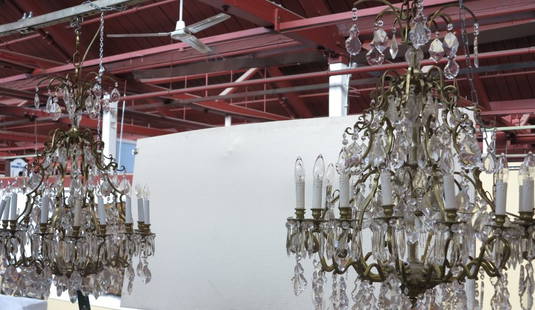 PAIR CHANDELIERS: A pair French style bronze and crystal chandeliers. The elaborate bronze multi-tier frames having sixteen lights each. The whole heavily decorated with large cut crystal tear drop pendants. 30"