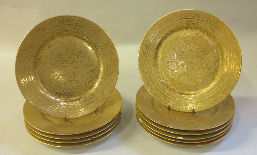SET ANTIQUE LIMOGES GILT PORCELAIN PLATES: 11, retailed by Ovington Bros., New York. Overall gilt floral decorated plates with foliate scrolled rim bands. Diam. 9 5/8."Chips to four rims. Provenance: Property from a Westwood, New Jersey Collec